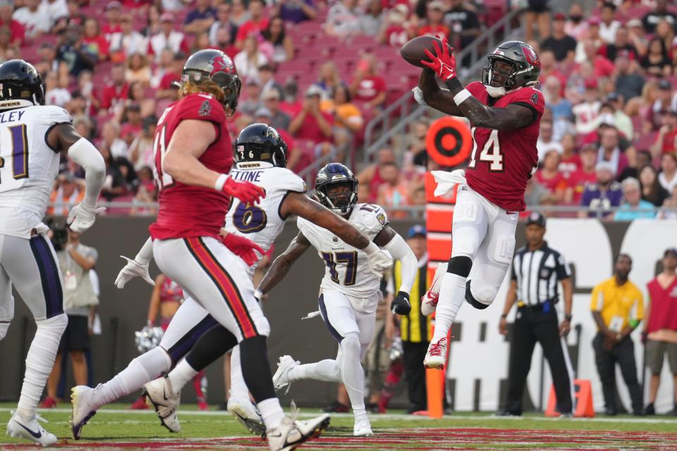 Tampa Bay Buccaneers wide receiver Chris Godwin (14) makes a touchdown reception int he first half during a preseason football game against the Baltimore Ravens, Saturday, Aug. 26, 2023, in Tampa, Fla.