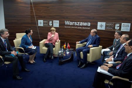 Germany's Chancellor Angela Merkel meets with Turkey's President Tayyip Erdogan at the NATO Summit in Warsaw, Poland July 9, 2016. Bundesregierung/Guido Bergmann/Handout via REUTERS