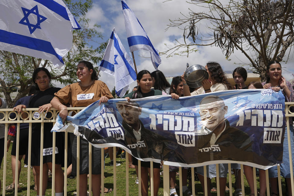 Supporters of Israeli Prime Minister Benjamin Netanyahu's government plans to overhaul the judicial system are gathered ahead of the weekly cabinet meeting in Sderot, Israel, near the border with the Gaza Strip, Thursday, April 20, 2023. (AP Photo/Tsafrir Abayov)