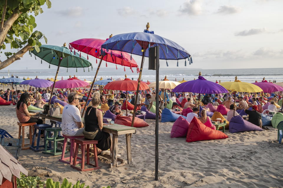 Tourists sit at Kuta beach in Bali, Indonesia, 27 Se Source: EPA/AAP