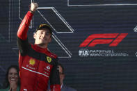 Ferrari driver Charles Leclerc of Monaco gestures as he gets onto the podium after winning the Australian Formula One Grand Prix in Melbourne, Australia, Sunday, April 10, 2022.Red Bull driver Sergio Perez, left, of Mexico was second. (AP Photo/Asanka Brendon Ratnayake)