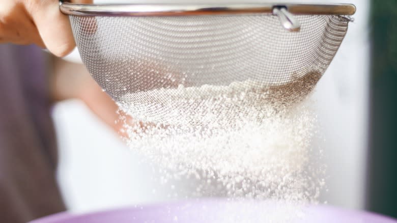 Sifting flour through sieve