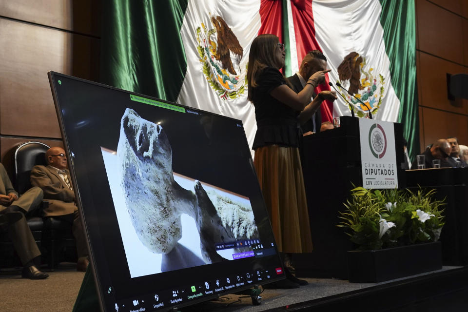 A speaker and a sign language translator present what they claim are extraterrestrial life forms, on a screen at the Chamber of Deputies in Mexico City, Tuesday, Nov. 7, 2023. Mexican legislators held another hearing dedicated to the potential for extraterrestrial life forms and UFOs following a controversial spectacle in September in which Mexican journalist Jaime Maussan displayed what he said were "non-human beings that are not part of our terrestrial evolution." (AP Photo/Marco Ugarte)
