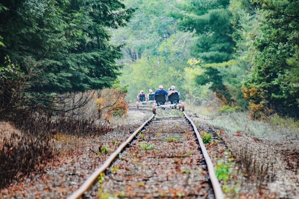 Customers ride rail bikes in Grawn, 10 miles outside of Traverse City, during Wheels on Rails opening season in summer 2023.