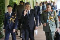 Malaysia's Defense Minister Mohamad Hasan, center, waves as he arrives for U.S.-South East Asia (SEA) Defense Ministers' Informal Meeting on the sidelines of the 20th International Institute for Strategic Studies (IISS) Shangri-La Dialogue, Asia's annual defense and security forum, in Singapore, Friday, June 2, 2023. (AP Photo/Vincent Thian)