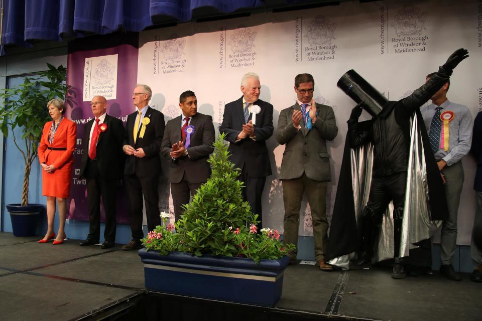 Theresa May stands alongside the other candidates in her Maidenhead constituency, including Lord Buckethead (r): Getty