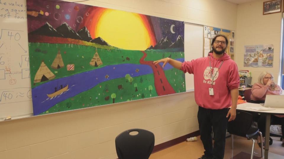 Standing next to a mural created by Mi'kmaw and non-Mi'kmaw students, Pictou said it is crucial for the Mi'kmaw language to be taught to the next generations. 