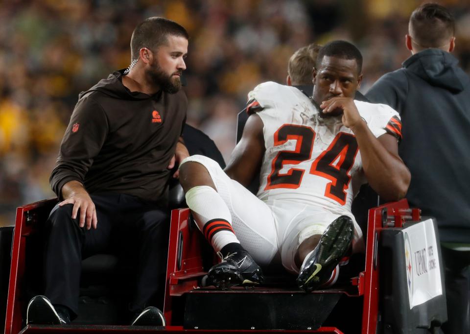 Cleveland Browns running back Nick Chubb (24) is taken from the field on a cart after suffering an apparent injury against the Pittsburgh Steelers during the second quarter at Acrisure Stadium.