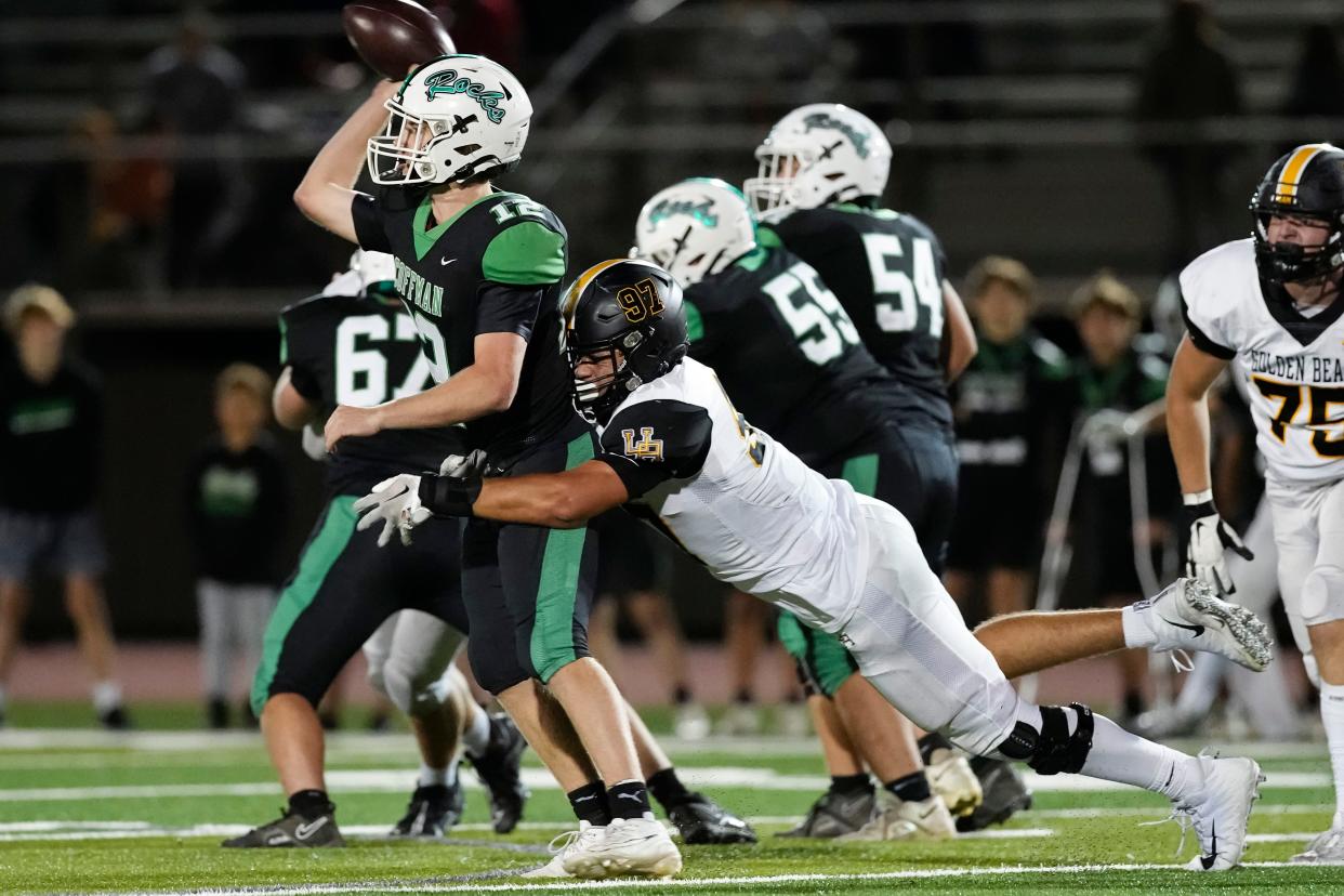 Upper Arlington defensive lineman Cal Thrush hits Dublin Coffman quarterback Quinn Hart during their game on Oct. 13.