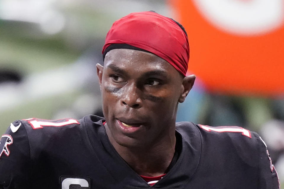 FILE - Atlanta Falcons wide receiver Julio Jones (11) leaves the field during the first half of an NFL football game against the New Orleans Saints in Atlanta, in this Sunday, Dec. 6, 2020, file photo. The Tennessee Titans have traded with the Atlanta Falcons for seven-time Pro Bowl wide receiver Julio Jones, a person familiar with the situation told The Associated Press. (AP Photo/Brynn Anderson, File)