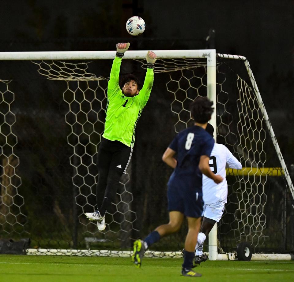 Centennial's Jorge Rojas (1) makes a save against Treasure Coast in a District 10-7A high school boys soccer semifinal, Monday, Jan. 29, 2024, at the South County Regional Sports Complex in Port St. Lucie.