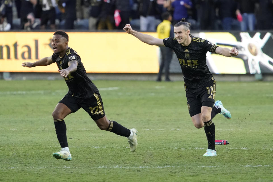 Los Angeles FC defender Diego Palacios (12) and forward Gareth Bale (11) celebrate after defeating the Philadelphia Union in a penalty kick shootout to win the MLS Cup soccer match Saturday, Nov. 5, 2022, in Los Angeles. (AP Photo/Marcio Jose Sanchez)