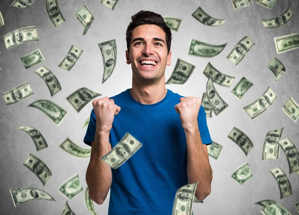 Money raining on smiling man