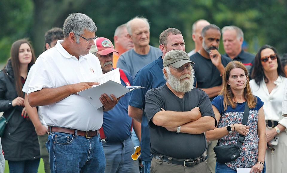 Bidders and some curious townspeople listen to the bidding start on Peaceful Meadows, a longtime dairy and ice cream stand in Whitman on Tuesday, Aug. 29, 2023.