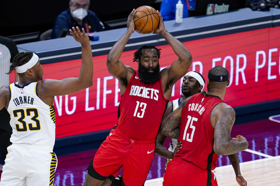 Houston Rockets guard James Harden (13) makes a pass in front of Indiana Pacers forward Myles Turner (33) during the third quarter of an NBA basketball game in Indianapolis, Wednesday, Jan. 6, 2021. (AP Photo/Michael Conroy)