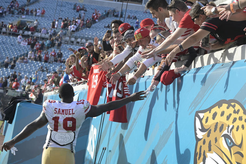 San Francisco 49ers wide receiver Deebo Samuel (19) high five fans after defeating the Jacksonville Jaguars in an NFL football game, Sunday, Nov. 21, 2021, in Jacksonville, Fla. (AP Photo/Phelan M. Ebenhack)