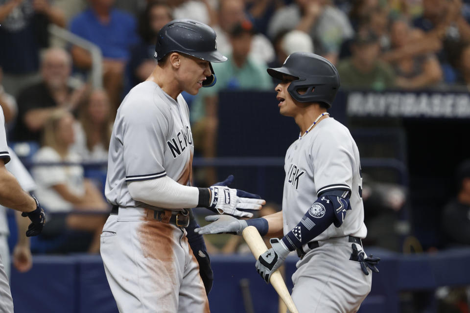 New York Yankees' Aaron Judge, left, celebrates with Oswaldo Cabrera after scoring against the Tampa Bay Rays during the seventh inning of a baseball game Sunday, Sept. 4, 2022, in St. Petersburg, Fla. Cabrera hit a sacrifice fly that allowed Judge to score. (AP Photo/Scott Audette)