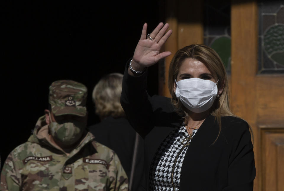 Bolivia's interim President Jeanine Anez, wearing a face mask to help curb the spread of the new coronavirus, waves during a procession Corpus Christi, in La Paz, Bolivia, Thursday, June 11, 2020. Anez has announced on Thursday, July 9, 2020, that she has tested positive for COVID-19. (AP Photo/Juan Karita)