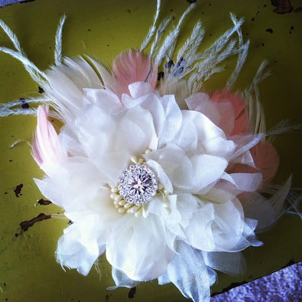 <div class="caption-credit"> Photo by: southerneverafter</div>So pretty and sweet. A classic look made from a white silk flower with crystals, seed pears, and feathers.