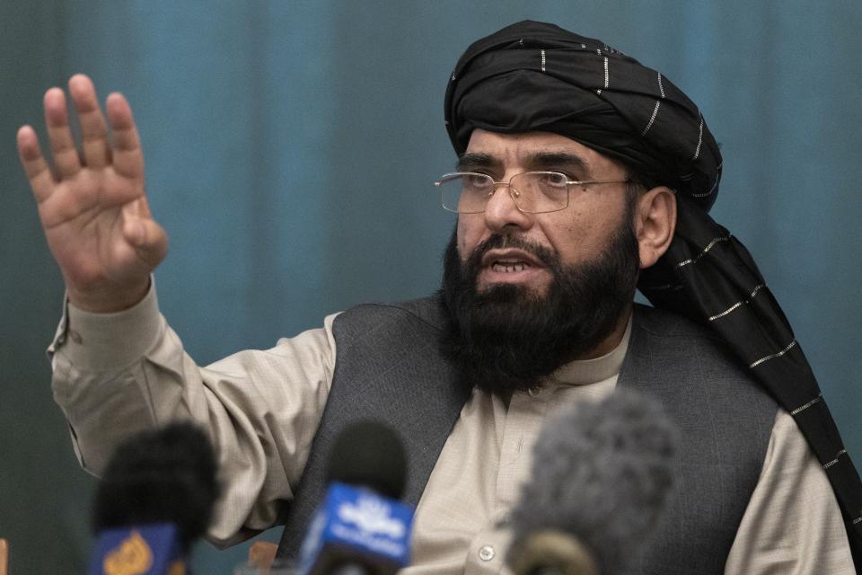 Suhail Shaheen, member of negotiation team gestures while speaking during a joint news conference in Moscow, Russia, Friday, March 19, 2021. The Taliban warned Washington against defying a May 1 deadline for the withdrawal of American and NATO troops from Afghanistan promising a "reaction". (AP Photo/Alexander Zemlianichenko, Pool)