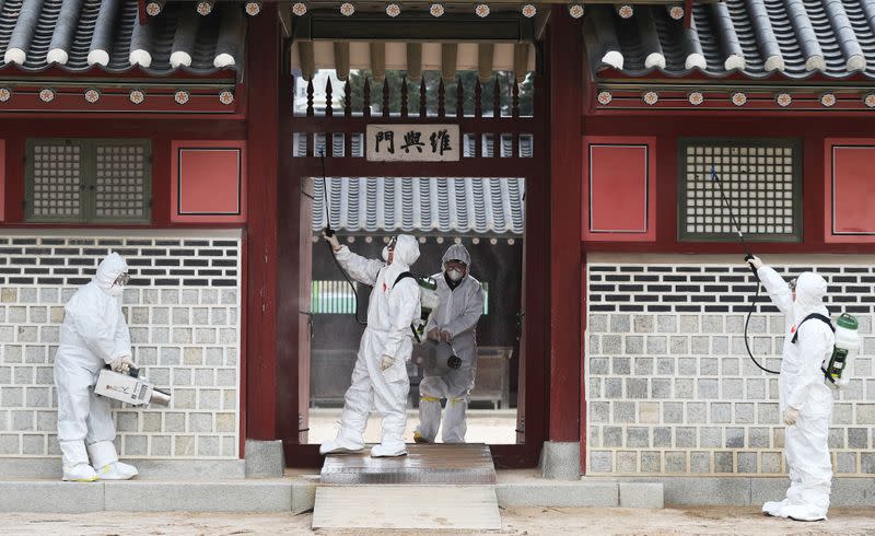 Officials from a public health center sanitize a traditional palace in Suwon