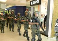 Soldiers patrol a shopping center in the city center during a police strike in Salvador, Bahia state, April 17, 2014. REUTERS/Valter Pontes