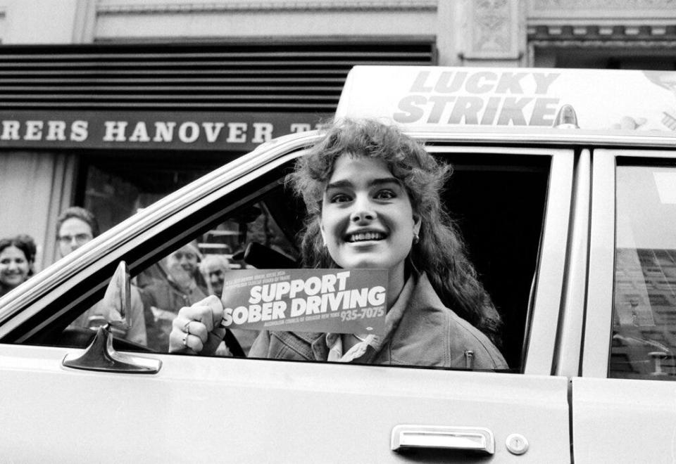 Brooke Shields holding an anti-drunk driving bumper sticker on December 15, 1983.