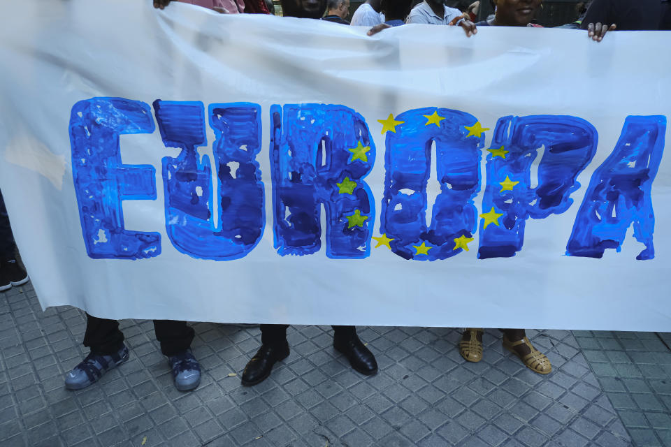 Demonstrators hold up a banner during one of many protests across Spain amid for the investigation over the deaths of at least 23 people at the border between the Spanish enclave of Melilla and Morocco, in Pamplona, northern Spain, Friday, July 1, 2022. (AP Photo/Alvaro Barrientos)