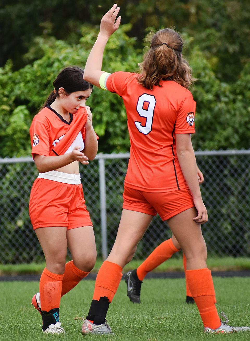 Diman's Elizabeth Kinnane (right) high fives Filipa Duarte after assisting her goal against Bristol-Plymouth.