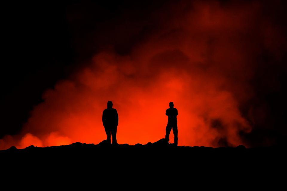 People look at the volcano erupting, north of Grindavík, Iceland, Thursday, Feb. 8, 2024. Iceland’s Meteorological Office says a volcano is erupting in the southwestern part of the country, north of a nearby settlement. The eruption of the Sylingarfell volcano began at 6 a.m. local time on Thursday, soon after an intense burst of seismic activity.