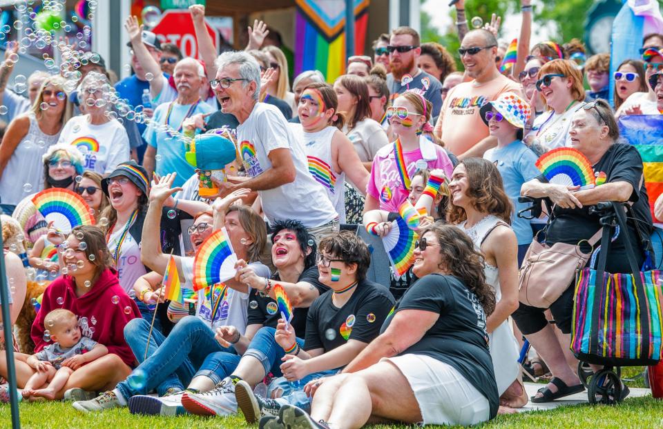 Tim Brown-Salsman, center, holds a bubble machine as attendees, organizers and performers gather for a group picture during the first annual Loogootee Pride Festival on Saturday, June 10, 2023.