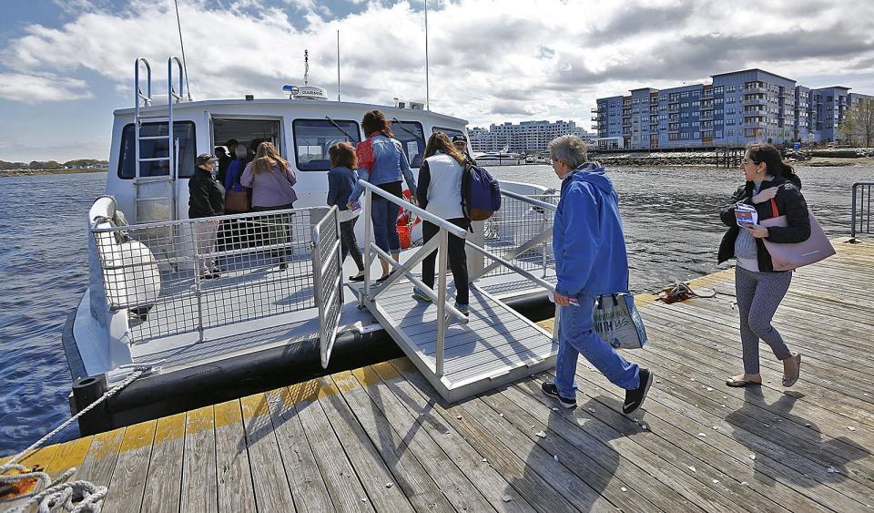 Guests board a ferry leaving from Squantum on April 24, 2019. The ferry project received $400,000 from a $4 billion spending bill passed by the legislature in December 2021.
