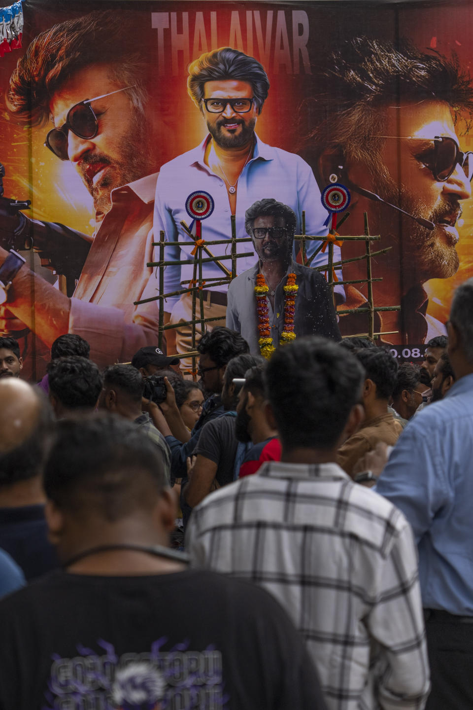 Fans of Indian superstar Rajinikanth, arrive to watch the screening of his latest film "Jailer" in Mumbai, India, Thursday, Aug. 10, 2023. (AP Photo/Rafiq Maqbool)