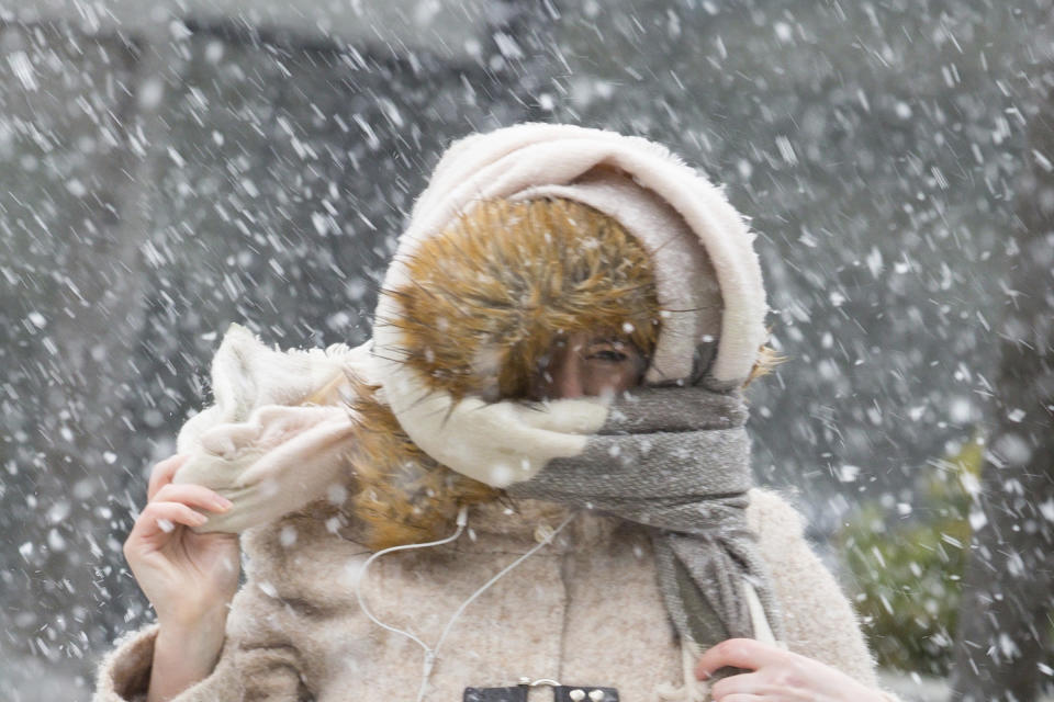 <p>A pedestrian holds onto her scarf against wind and snow in Philadelphia, Friday, March 2, 2018. (Photo: Jessica Griffin/The Philadelphia Inquirer via AP) </p>