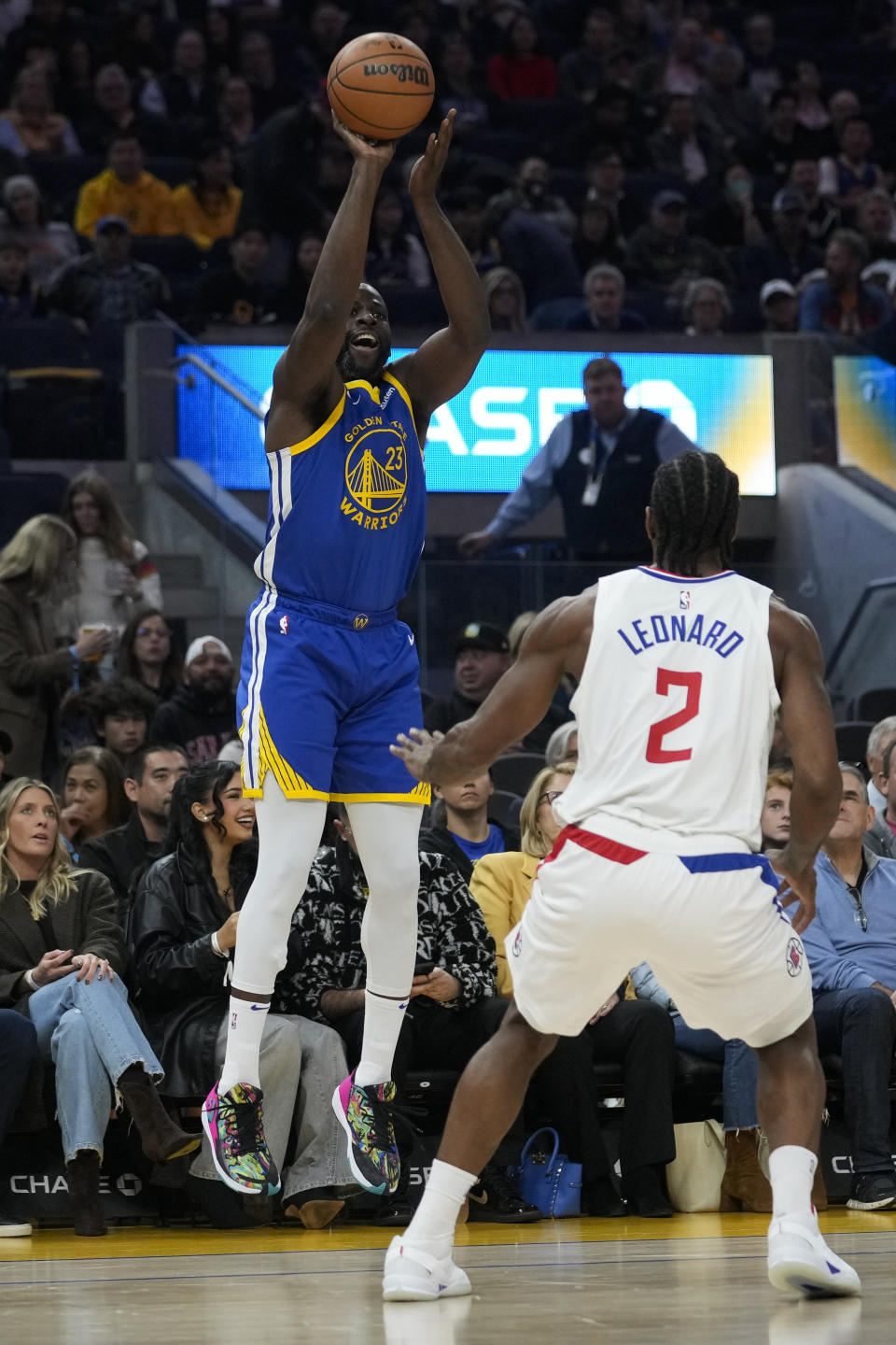 Golden State Warriors forward Draymond Green shoots a 3-point basket in front of Los Angeles Clippers forward Kawhi Leonard during the first half of an NBA basketball game Thursday, Nov. 30, 2023, in San Francisco. (AP Photo/Godofredo A. Vásquez)