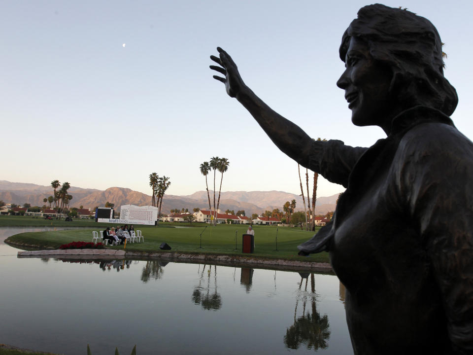 FILE - A statue of actress Dinah Shore, long time tournament host, frames LPGA tour chaplain Cris Steven as he speaks during an Easter sunrise service before the final round of the LPGA Kraft Nabisco Championship golf tournament in Rancho Mirage, Calif., in this Sunday, April 4, 2010, file photo. The LPGA's first major is leaving after more than 50 years in the Palm Springs area. (AP Photo/Chris Carlson)