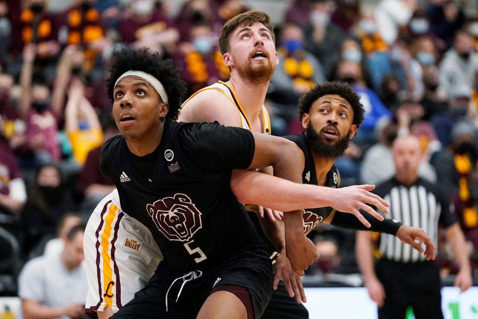 Loyola Chicago forward Ryan Schwieger, center, battles for a rebound against Missouri State guards Donovan Clay, left, and Jaylen Minnett during the second half of an NCAA college basketball game in Chicago, Saturday, Jan. 22, 2022. (AP Photo/Nam Y. Huh)