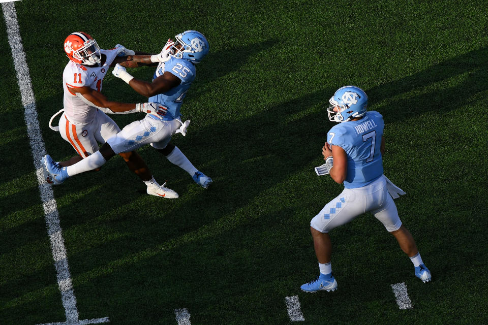 CHAPEL HILL, NC - SEPTEMBER 28: Clemson Tigers linebacker Isaiah Simmons (11) fights to get past North Carolina Tar Heels running back Javonte Williams (25) and get the sack on North Carolina Tar Heels quarterback Sam Howell (7) as he looks to pass in the game between the Clemson Tigers and the North Carolina Tar Heels on September 28, 2019 at Kenen Memorial Stadium in Chapel Hill, NC.(Photo by Dannie Walls/Icon Sportswire via Getty Images)