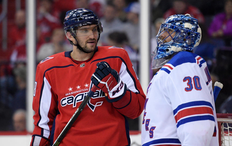 FILE - In this March 28, 2018, file photo, Washington Capitals left wing Alex Ovechkin (8), of Russia, with New York Rangers goaltender Henrik Lundqvist (30), of Sweden, during the second period of an NHL hockey game in Washington. Lundqvist signed with the Capitals when free agency opened Friday, Oct. 9, 2020. (AP Photo/Nick Wass, File)