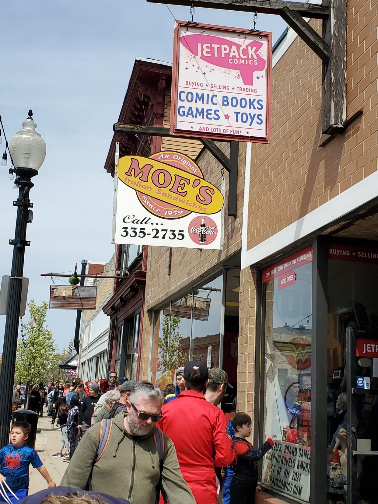 The line waiting to enter Jetpack Comics stretches out of sight as people came for Free Comic Book Day in Rochester Saturday, May 7, 2022.