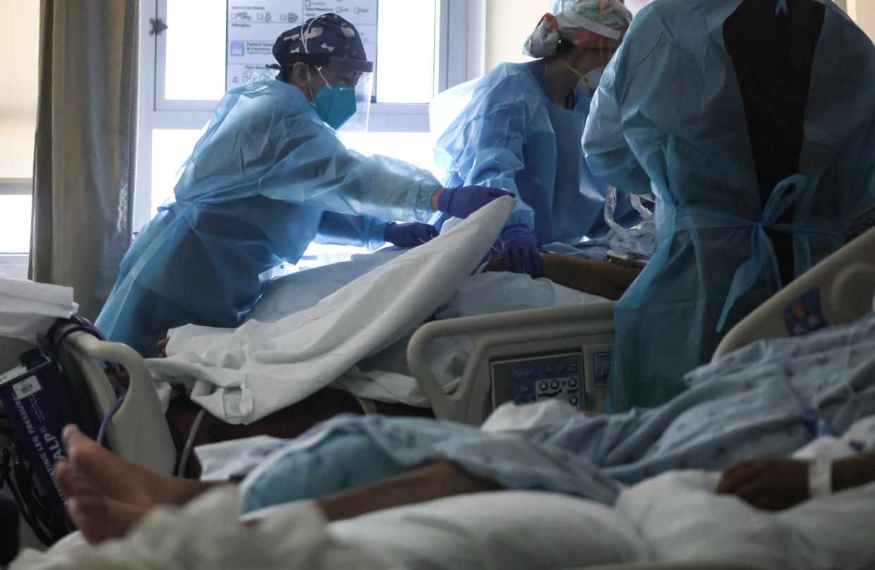 Clinicians care for COVID-19 patients in a makeshift ICU (Intensive Care Unit) at Harbor-UCLA Medical Center on Jan. 21, 2021, in Torrance, Calif. The hospital is over its ICU capacity due to the coronavirus and has been forced to treat multiple COVID-19 patients who require ICU level care together in converted rooms that were designed for lower levels of care. California has become the first state in the nation to record 3 million known COVID-19 infections. Los Angeles County reported more than 250 COVID-19 fatalities on January 21.