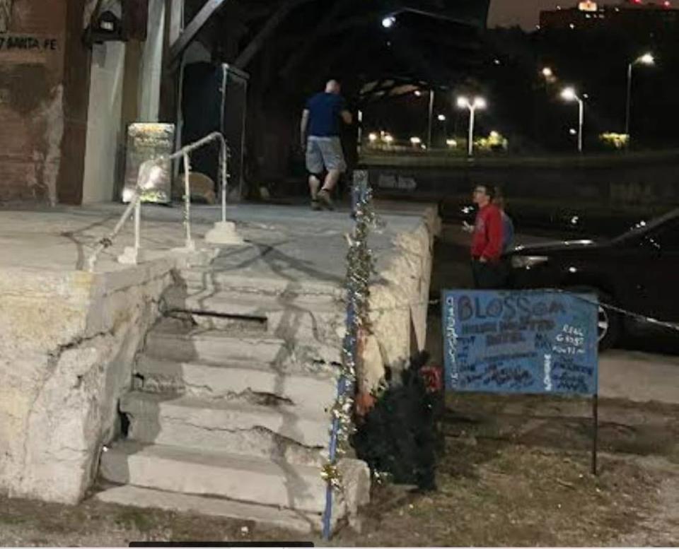 Near a handmade sign, crumbling steps lead to the Blossom House Haunted Hotel at 817 Santa Fe St. in Kansas City’s West Bottoms.