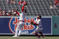 Los Angeles Angels shortstop Jose Iglesias, left, catches a fly ball with third baseman David Fletcher, right, backing him up, on a ball hit by Oakland Athletics designated hitter Mitch Moreland during the seventh inning of a baseball game in Anaheim, Calif., Saturday, July 31, 2021. (AP Photo/Alex Gallardo)