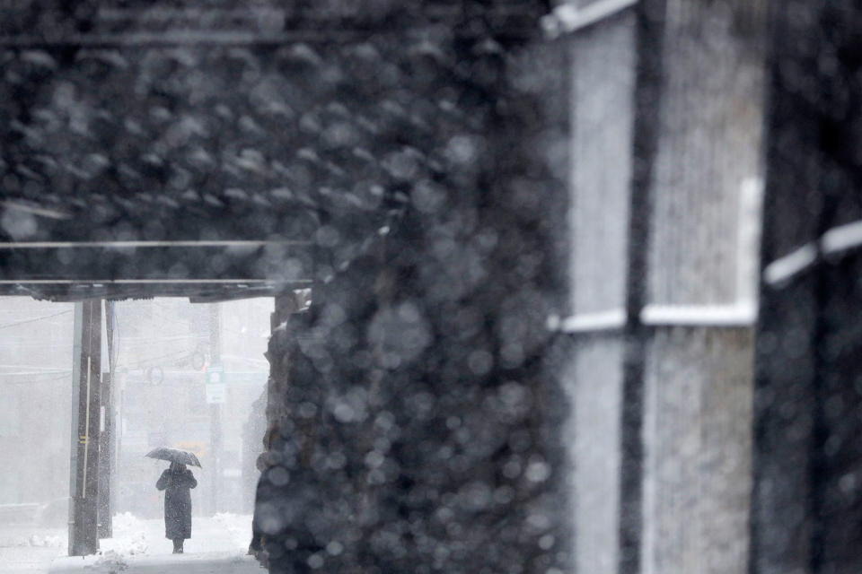 <p>A woman uses an umbrella while shielding herself from a snowstorm, Wednesday, March 21, 2018, in Hoboken, N.J. (Photo: Julio Cortez/AP) </p>