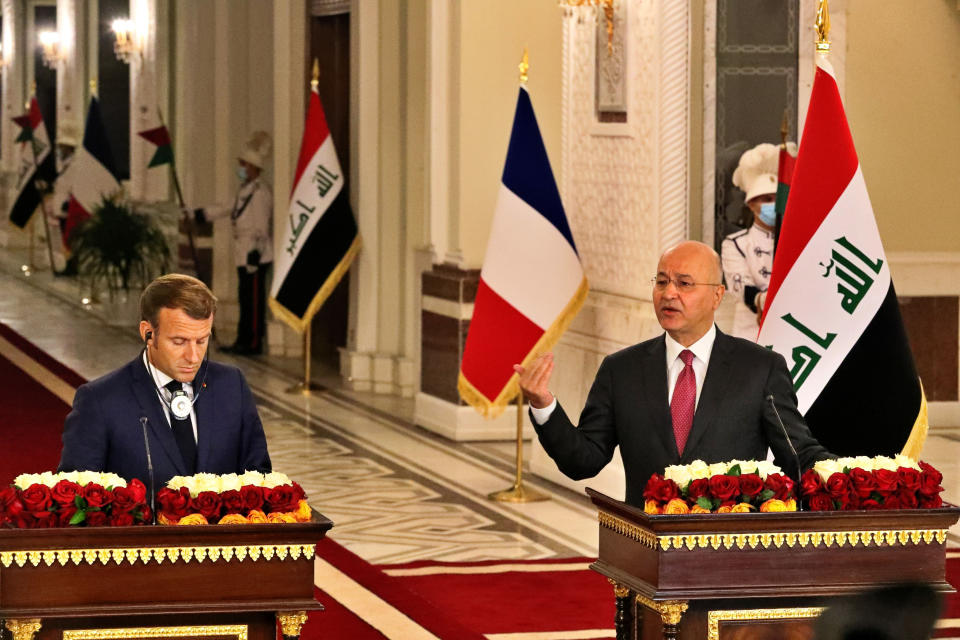 French President Emmanuel Macron, left, and Iraq's President Barham Salihat, right, give a news conference at the presidential palace, in Baghdad, Iraq, Wednesday, Sept. 2, 2020. Macron is the first head of state to visit the Iraqi capital since the country's new prime minister and Iraq’s former intelligence chief formed a government in May. (AP Photo/Khalid Mohammed)