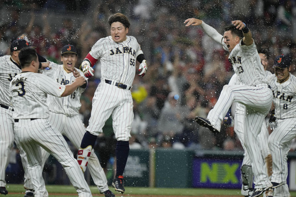 Japan players celebrate after beating Mexico 6-5 during a World Baseball Classic game, Monday, March 20, 2023, in Miami. (AP Photo/Wilfredo Lee)