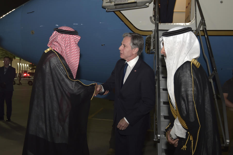 Secretary of State Antony Blinken, center, shakes hands with a Saudi official upon his arrival, Tuesday, June 6, 2023 in Jedda, Saudi Arabia. (Amer Hilabi/Pool via AP)