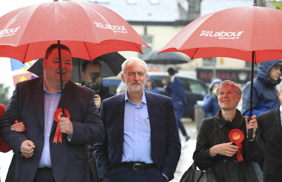 Labour Party leader Jeremy Corbyn, center, arrives Friday May 3, 2019 to celebrate the election result for Trafford Council with Labour Party activists at the Waterside Arts Centre, Manchester, England, following the voting in Thursday's English council elections. (Peter Byrne/PA via AP)