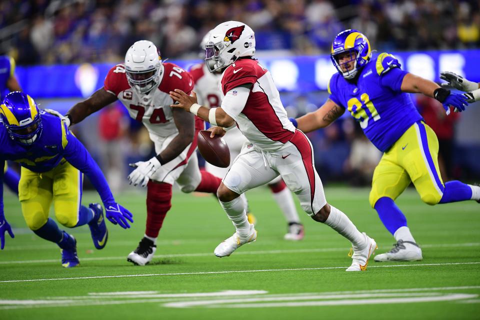 Jan 17, 2022; Inglewood, California, USA; Arizona Cardinals quarterback Kyler Murray (1) runs the ball against the Los Angeles Rams defense during the first half in the NFC Wild Card playoff football game at SoFi Stadium.