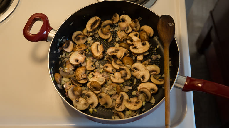 mushrooms sauteing in large pan 